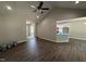 Bright open-concept living room with hardwood floors, vaulted ceiling, and access to the kitchen at 1000 Peedin Rd, Selma, NC 27576