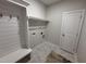 This mud room area includes a bench, hooks and shelving to stay organized and functional with ease at 1000 Peedin Rd, Selma, NC 27576