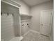 Convenient mud room with coat hooks, storage, and stylish flooring for organization near entrance at 1000 Peedin Rd, Selma, NC 27576