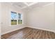 Bright room featuring coffered ceilings, hardwood floors, and natural light from the large window at 1000 Peedin Rd, Selma, NC 27576