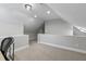 Spacious attic featuring neutral carpet and a clean, functional layout, ideal for storage or additional living space at 1013 Whitney Springs Ct, Holly Springs, NC 27540