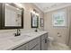 Bathroom featuring a double sink vanity, quartz counters and shaker-style cabinets at 1013 Whitney Springs Ct, Holly Springs, NC 27540