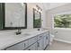 Bathroom features a double sink vanity, quartz counters and shaker-style cabinets at 1013 Whitney Springs Ct, Holly Springs, NC 27540