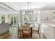 Bright breakfast nook with large windows, modern lighting, and a cozy table for casual dining at 1013 Whitney Springs Ct, Holly Springs, NC 27540
