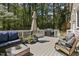 Inviting deck with outdoor seating, grill, and umbrella, perfect for entertaining or relaxing in a wooded setting at 1013 Whitney Springs Ct, Holly Springs, NC 27540