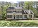 Charming two-story home featuring classic architectural design and a well-manicured front yard with mature trees at 1013 Whitney Springs Ct, Holly Springs, NC 27540