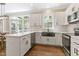 Modern kitchen featuring white cabinets, stainless steel appliances, and a stylish backsplash for a functional design at 1013 Whitney Springs Ct, Holly Springs, NC 27540