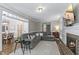 Comfortable living room with fireplace, large sectional sofa, and seamless access to the dining area at 1013 Whitney Springs Ct, Holly Springs, NC 27540
