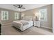 A serene main bedroom with lots of natural light and a king bed at 1013 Whitney Springs Ct, Holly Springs, NC 27540