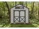 Well-maintained shed with double doors and a neutral color scheme, perfect for storing outdoor equipment or tools at 1013 Whitney Springs Ct, Holly Springs, NC 27540