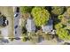 An aerial view displays a charming property nestled among lush trees and well-manicured greenery at 104 E Wilson St, Mebane, NC 27302