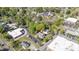 An aerial view showcases a charming neighborhood with tree-lined streets and a traditional church nearby at 104 E Wilson St, Mebane, NC 27302