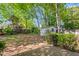 Backyard with mature trees and shed at 104 E Wilson St, Mebane, NC 27302