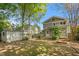 Well-maintained backyard featuring a small shed and mature trees, fenced-in at 104 E Wilson St, Mebane, NC 27302
