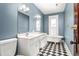 Stylish bathroom with checkerboard floors, double vanity, and a classic clawfoot tub at 104 E Wilson St, Mebane, NC 27302