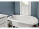 This bathroom features a classic clawfoot tub and black and white checkerboard flooring at 104 E Wilson St, Mebane, NC 27302