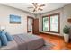 Comfortable bedroom with hardwood floors, ceiling fan, and a view to the attached half-bathroom at 104 E Wilson St, Mebane, NC 27302
