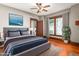 Comfortable bedroom with hardwood floors, ceiling fan, and stylish decor at 104 E Wilson St, Mebane, NC 27302