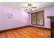 Bedroom with wood floors, wood trim, ceiling fan and Winnie the Pooh décor at 104 E Wilson St, Mebane, NC 27302