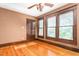 Bedroom with wood floors, wood trim, three windows and ceiling fan at 104 E Wilson St, Mebane, NC 27302