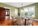 Bright dining room with dining table, chairs, and green walls at 104 E Wilson St, Mebane, NC 27302