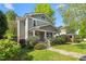 Charming two-story home with a welcoming front porch and well-maintained landscaping on a sunny day at 104 E Wilson St, Mebane, NC 27302