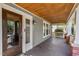 Inviting front porch with wood ceiling and brick accents at 104 E Wilson St, Mebane, NC 27302