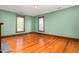 Inviting living room features hardwood floors and natural light from two bright windows at 104 E Wilson St, Mebane, NC 27302