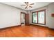 Hardwood floored living room with ceiling fan and large windows providing great natural light at 104 E Wilson St, Mebane, NC 27302