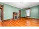Inviting living room features wood trim, a decorative fireplace, and rich hardwood floors at 104 E Wilson St, Mebane, NC 27302