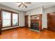 Spacious living room with hardwood floors, fireplace, and natural light through the windows at 104 E Wilson St, Mebane, NC 27302