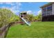 Backyard features green grass with a wooden playset and slide at 1093 Trentini Ave, Wake Forest, NC 27587