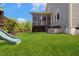 Wide backyard with green grass, playset and enclosed porch at 1093 Trentini Ave, Wake Forest, NC 27587