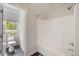 Bright bathroom featuring a white shower and toilet with tiled floor, and natural light at 1093 Trentini Ave, Wake Forest, NC 27587