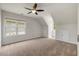 Spacious bedroom with neutral carpet, a ceiling fan, and ample natural light from several windows at 1093 Trentini Ave, Wake Forest, NC 27587