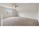 Large bonus room with a ceiling fan, neutral carpet, and dormer windows at 1093 Trentini Ave, Wake Forest, NC 27587