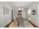 Formal dining room features hardwood floors, chandelier, and natural light at 1093 Trentini Ave, Wake Forest, NC 27587