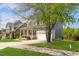 Suburban two-story home featuring a cozy front porch, attached garage, and well-maintained lawn at 1093 Trentini Ave, Wake Forest, NC 27587