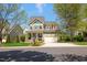 Beautiful two-story home features a front porch, manicured lawn, and a two-car garage at 1093 Trentini Ave, Wake Forest, NC 27587