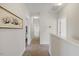 Bright upstairs hallway with neutral walls and carpet leading to various rooms in the home at 1093 Trentini Ave, Wake Forest, NC 27587