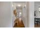 Hallway with hardwood floors and decorative wall art leading to other rooms at 1093 Trentini Ave, Wake Forest, NC 27587