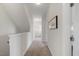 Upstairs hallway with neutral carpet, white walls, and natural light at 1093 Trentini Ave, Wake Forest, NC 27587