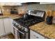 Close-up of a stove with granite countertop and stainless steel oven at 1093 Trentini Ave, Wake Forest, NC 27587