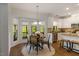Eat-in kitchen boasting stainless appliances, granite countertops, and a breakfast nook with bay window at 1093 Trentini Ave, Wake Forest, NC 27587