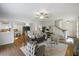 Bright living room featuring hardwood floors, ceiling fan, and cozy seating arrangement at 1093 Trentini Ave, Wake Forest, NC 27587