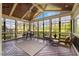 Cozy screened porch featuring a wood ceiling, rustic decor, and view of mature trees at 1093 Trentini Ave, Wake Forest, NC 27587