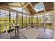 Inviting screened porch with wood ceiling, rustic decor, and a view of the surrounding greenery at 1093 Trentini Ave, Wake Forest, NC 27587
