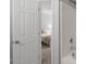 Bathroom view featuring a soaking tub, white tiled walls, and a door to the bedroom at 11210 Lofty Heights Pl, Raleigh, NC 27614
