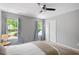 Inviting bedroom with a ceiling fan, two windows with view, and plush carpeting at 11210 Lofty Heights Pl, Raleigh, NC 27614