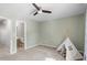Neutral bedroom featuring soft carpet, a modern ceiling fan, and a whimsical teepee for a cozy touch at 11210 Lofty Heights Pl, Raleigh, NC 27614